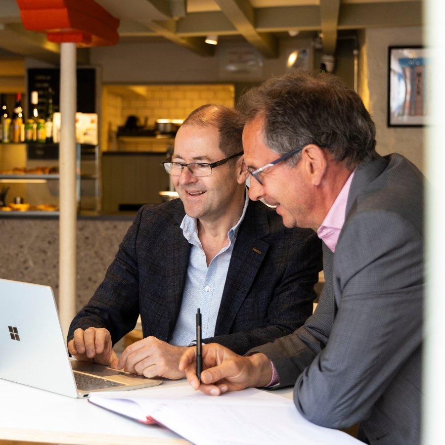 Team Photos for FDPack - Fractional Finance Services in Southwell - Simon and Spencer working together on a laptop in a local coffee shop