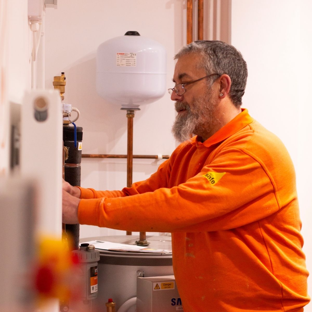 Team photos for The Glow Group, Lincolnshire - a team member fixing a thermostat