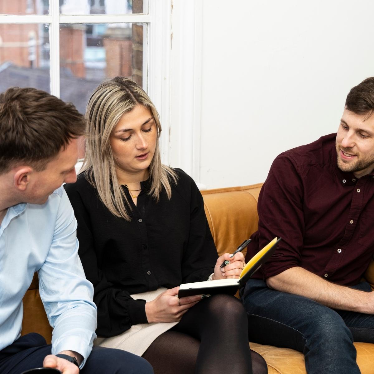 Team Photos with Node Building Consultancy, Nottingham - a team meeting of three people sat on a sofa in front of a window.
